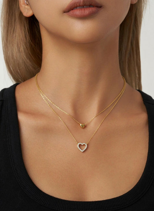 Necklace with a pendant worn by a person against a neutral background